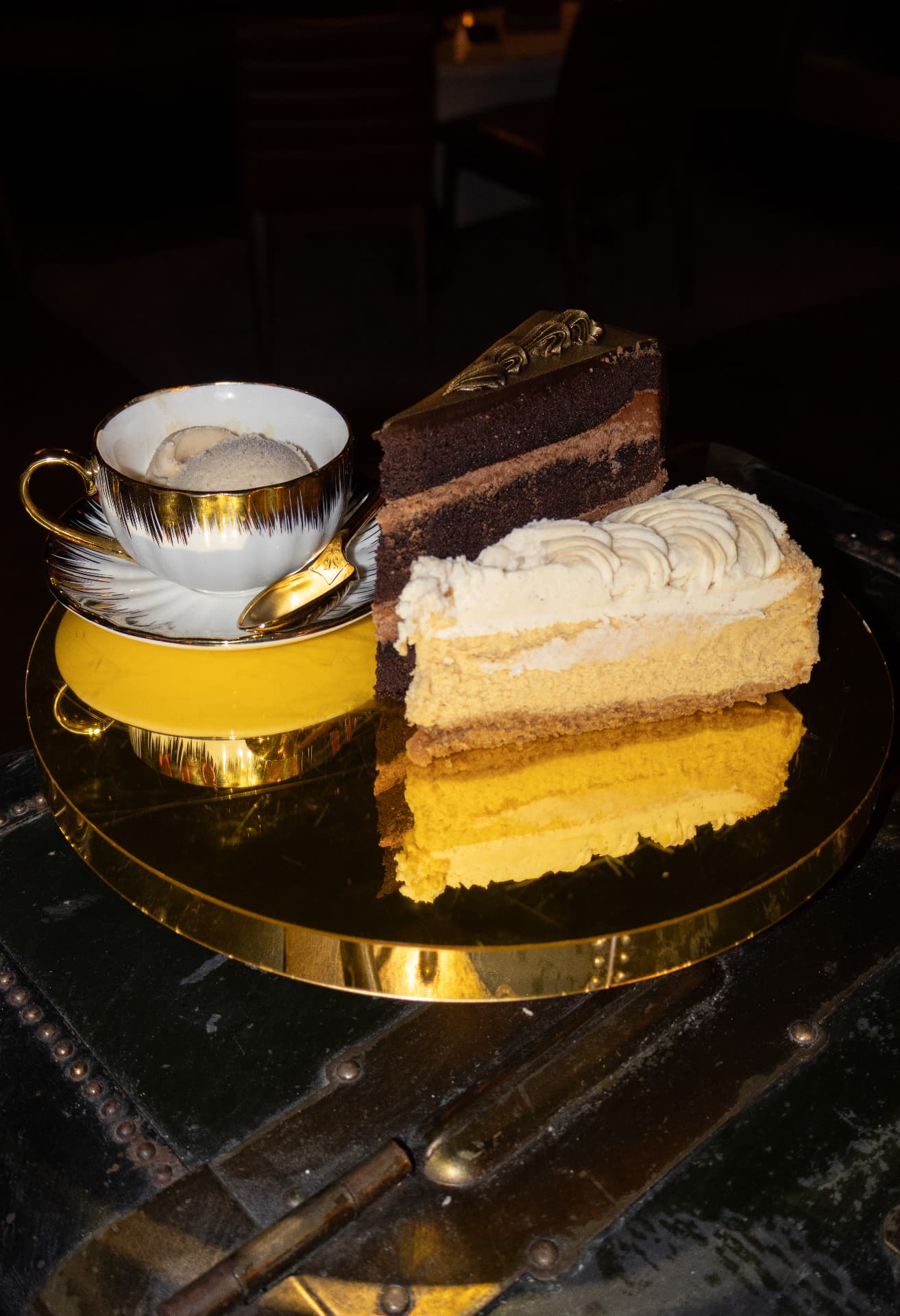 Chocolate and vanilla layer cakes with ice cream on a gold tray at Society